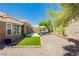 Private backyard with manicured landscaping, gravel, artificial turf, and a relaxing hot tub at 2705 Tumble Brook Dr, Las Vegas, NV 89134