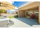 Backyard with hot tub, covered patio seating area, and manicured landscaping at 2705 Tumble Brook Dr, Las Vegas, NV 89134