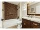 Well-appointed bathroom with a tiled shower-tub combination, stylish vanity, and modern fixtures at 2705 Tumble Brook Dr, Las Vegas, NV 89134