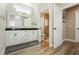 Bright bathroom featuring a double vanity, sleek countertop, and a glass-enclosed shower for a luxurious feel at 2705 Tumble Brook Dr, Las Vegas, NV 89134
