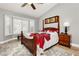 Bedroom featuring wood look flooring, bay window and custom plantation shutters for adjustable natural light at 2705 Tumble Brook Dr, Las Vegas, NV 89134