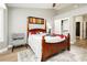 Cozy bedroom with wood-look flooring, custom ceiling fan and convenient walk-in closet access at 2705 Tumble Brook Dr, Las Vegas, NV 89134