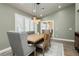 Formal dining room with modern chandelier, neutral walls, and custom window shutters for natural light at 2705 Tumble Brook Dr, Las Vegas, NV 89134