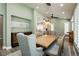 Inviting dining room showcasing modern chandelier, custom window shutters and seamless access to kitchen at 2705 Tumble Brook Dr, Las Vegas, NV 89134