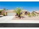Charming single-story home featuring a desert landscape, mature palm tree, and a neutral color palette at 2705 Tumble Brook Dr, Las Vegas, NV 89134