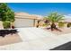 Beautiful exterior view with desert landscaping and a well-maintained front yard, complemented by a spacious driveway at 2705 Tumble Brook Dr, Las Vegas, NV 89134
