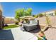 Backyard featuring a hot tub, patio, manicured landscaping, and block fence at 2705 Tumble Brook Dr, Las Vegas, NV 89134