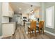 Open kitchen featuring wooden floors, bar seating, stainless steel appliances and bright white cabinetry at 2705 Tumble Brook Dr, Las Vegas, NV 89134