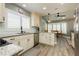 Bright kitchen featuring stone countertops, stainless steel appliances, and a full view into the breakfast nook at 2705 Tumble Brook Dr, Las Vegas, NV 89134