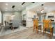 Inviting kitchen and dining room with seamless flow, bar seating, and modern lighting fixtures at 2705 Tumble Brook Dr, Las Vegas, NV 89134