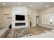 Inviting living room with a cozy fireplace, modern accents, and stylish wood-look flooring at 2705 Tumble Brook Dr, Las Vegas, NV 89134