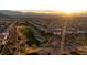 Stunning aerial view of a lush golf course community at sunset, with beautiful mountain views at 2742 Darby Falls Dr, Las Vegas, NV 89134