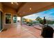 Relaxing covered patio with tiled flooring, views, and a built-in countertop area for outdoor dining at 2742 Darby Falls Dr, Las Vegas, NV 89134