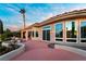 Expansive backyard patio with tiled surface, water feature, mature landscaping, and seamless transition to indoor living at 2742 Darby Falls Dr, Las Vegas, NV 89134