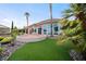 Back of house features a covered patio, rock landscaping, and small grass area at 2742 Darby Falls Dr, Las Vegas, NV 89134