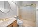 A bathroom with a vanity, toilet, and shower with gold trim at 2742 Darby Falls Dr, Las Vegas, NV 89134