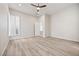 Bright bedroom with light wood floors, ceiling fan, and windows with shutters at 2742 Darby Falls Dr, Las Vegas, NV 89134
