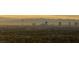 Distant city skyline at dusk, creating a serene and picturesque backdrop against a hazy horizon at 2742 Darby Falls Dr, Las Vegas, NV 89134
