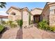 Front exterior of house with flagstone walkway, desert landscaping, and palm trees at 2742 Darby Falls Dr, Las Vegas, NV 89134