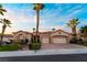 Elegant single-story home featuring mature palm trees, a three-car garage, and well-maintained landscaping at 2742 Darby Falls Dr, Las Vegas, NV 89134