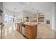 Bright kitchen with a central island, stainless steel appliances, and an adjacent living space at 2742 Darby Falls Dr, Las Vegas, NV 89134
