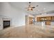 Open-concept living room with fireplace, tile floors, and view of kitchen at 2742 Darby Falls Dr, Las Vegas, NV 89134