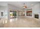 Open living area features a fireplace, built-in shelving, and access to an outdoor patio at 2742 Darby Falls Dr, Las Vegas, NV 89134