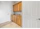 Functional mud room features wooden cabinets for storage and elegant tile flooring at 2742 Darby Falls Dr, Las Vegas, NV 89134