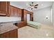 Home office with Murphy bed, built-in desk and cabinets, ceiling fan, and tile flooring at 2742 Darby Falls Dr, Las Vegas, NV 89134