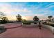 Outdoor patio with landscaping showcasing scenic city views, palm trees, and golf course at 2742 Darby Falls Dr, Las Vegas, NV 89134