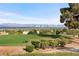 Panoramic view of the city skyline from a golf course and lush landscaping at 2742 Darby Falls Dr, Las Vegas, NV 89134