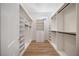 Spacious walk-in closet with custom shelves, drawers, and hanging rods for optimal organization at 2742 Darby Falls Dr, Las Vegas, NV 89134