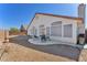 Backyard patio area with table and chairs beneath a blue sky at 2753 Trickling Brook Ct, Las Vegas, NV 89156