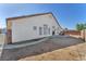 Backyard view showcasing a white stucco home with arched windows and a tiled roof at 2753 Trickling Brook Ct, Las Vegas, NV 89156