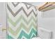 Bathroom featuring a toilet and a shower with colorful chevron pattern curtain at 2753 Trickling Brook Ct, Las Vegas, NV 89156