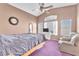 Bright bedroom boasts natural light, ceiling fan, and a sitting area with comfortable seating at 2753 Trickling Brook Ct, Las Vegas, NV 89156