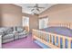 Spacious bedroom features a ceiling fan, a cozy couch and an oversized bed at 2753 Trickling Brook Ct, Las Vegas, NV 89156
