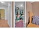 View of open walk-in closet filled with neatly arranged hanging clothes and storage containers at 2753 Trickling Brook Ct, Las Vegas, NV 89156