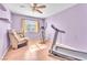 Exercise room with wood floors, couch, and exercise equipment at 2753 Trickling Brook Ct, Las Vegas, NV 89156