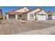 Inviting single-story home with desert landscaping, covered front porch, and attached garage at 2753 Trickling Brook Ct, Las Vegas, NV 89156