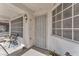 Close-up of a welcoming front porch with a security gate and outdoor seating at 2753 Trickling Brook Ct, Las Vegas, NV 89156
