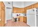 Functional kitchen featuring wood cabinets, white appliances, and tile countertops at 2753 Trickling Brook Ct, Las Vegas, NV 89156