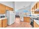 Bright kitchen with light wood cabinets, white appliances, and an open layout at 2753 Trickling Brook Ct, Las Vegas, NV 89156