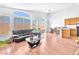 Spacious living area with large windows, hardwood floors, and open to the kitchen area at 2753 Trickling Brook Ct, Las Vegas, NV 89156