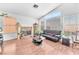 Comfortable living room featuring hardwood floors, large windows, and a cozy fireplace at 2753 Trickling Brook Ct, Las Vegas, NV 89156