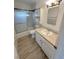 Bathroom with shower-tub combo, updated vanity and toilet for a clean, modern feel at 2804 E Gowan Rd, North Las Vegas, NV 89030
