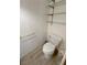 A tidy powder room featuring a toilet with tiled floor and gold tone fixtures at 2804 E Gowan Rd, North Las Vegas, NV 89030