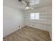 Bright bedroom featuring tiled flooring, white walls, and convenient shelving for storage at 2804 E Gowan Rd, North Las Vegas, NV 89030