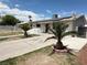 Charming single-story home with solar panels, desert landscaping, and a spacious driveway at 2804 E Gowan Rd, North Las Vegas, NV 89030