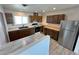 Cozy kitchen with wooden cabinets, stainless steel fridge, and ample counter space at 2804 E Gowan Rd, North Las Vegas, NV 89030